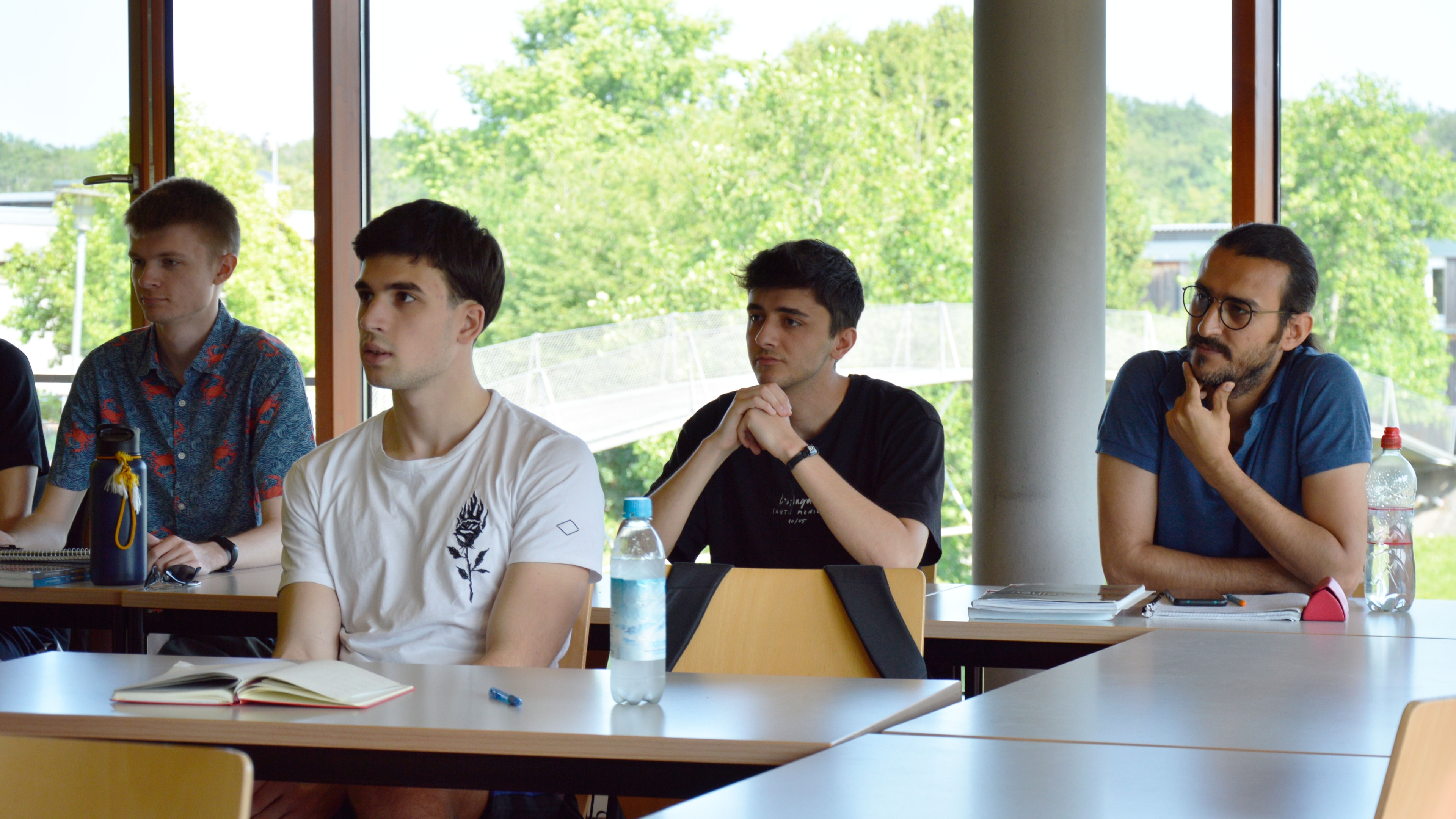 Students sit in class and listen attentively.