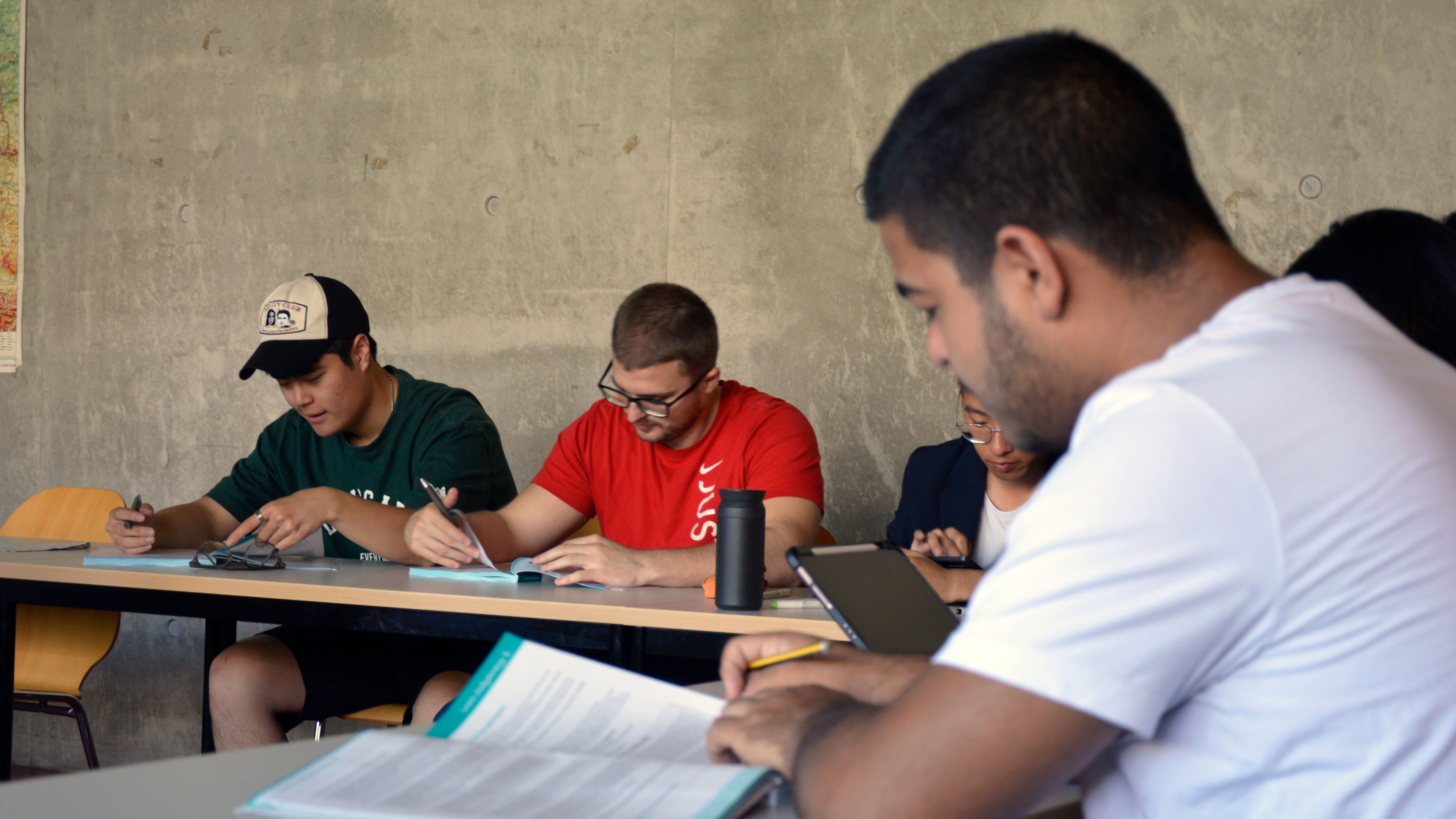 Students sit in the classroom and concentrate on their work.
