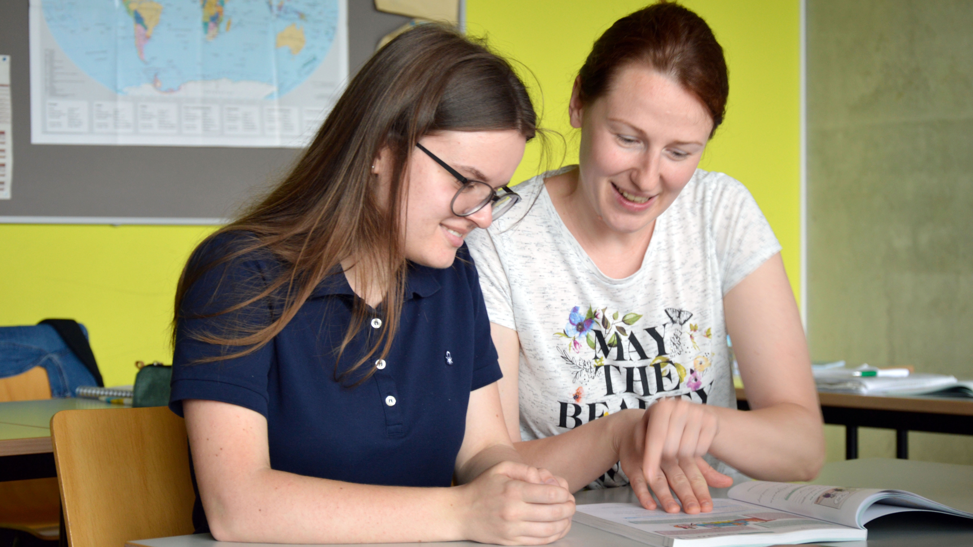 Two students discuss a task together.