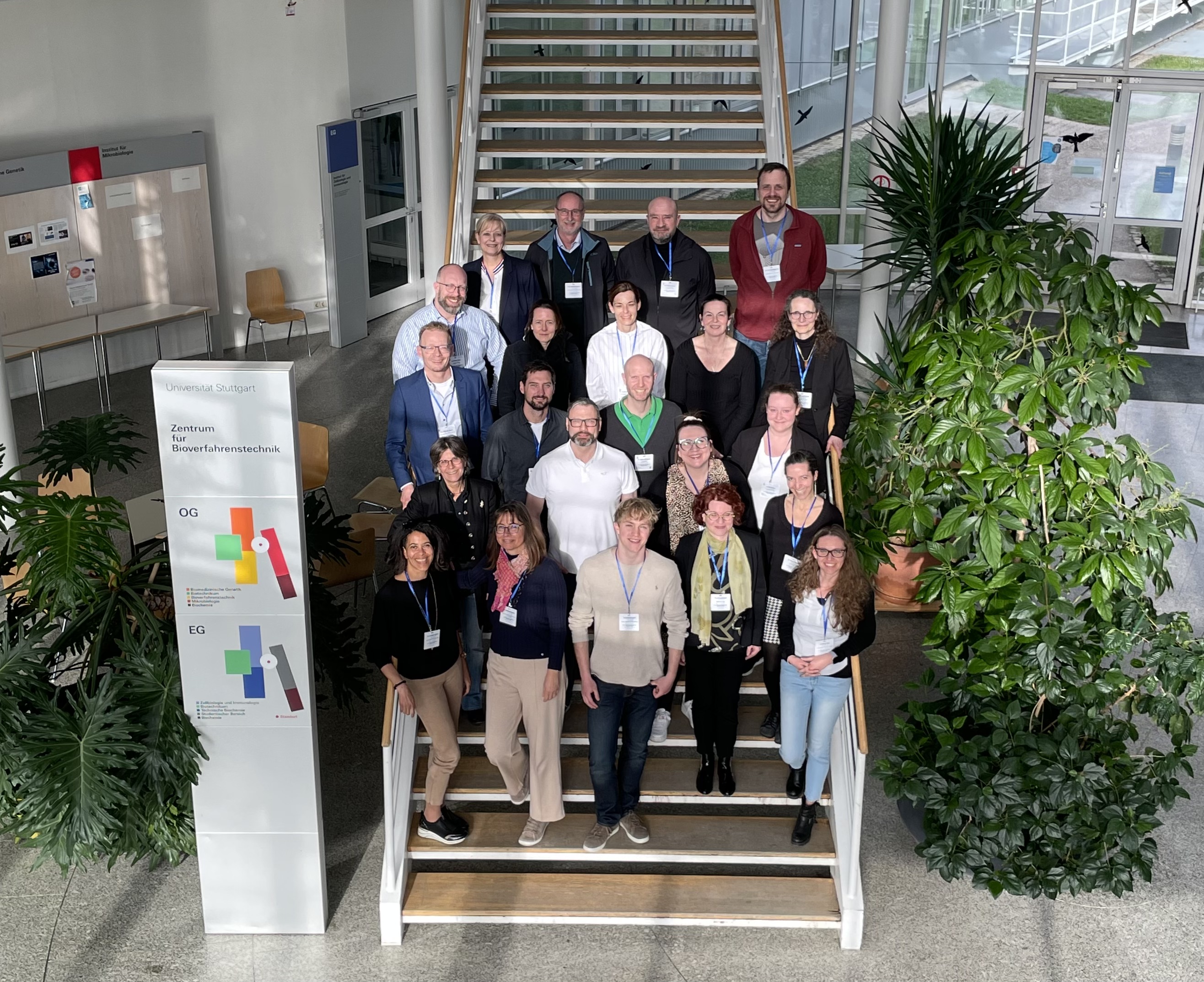 The participants of the conference have gathered on a staircase for a photo.