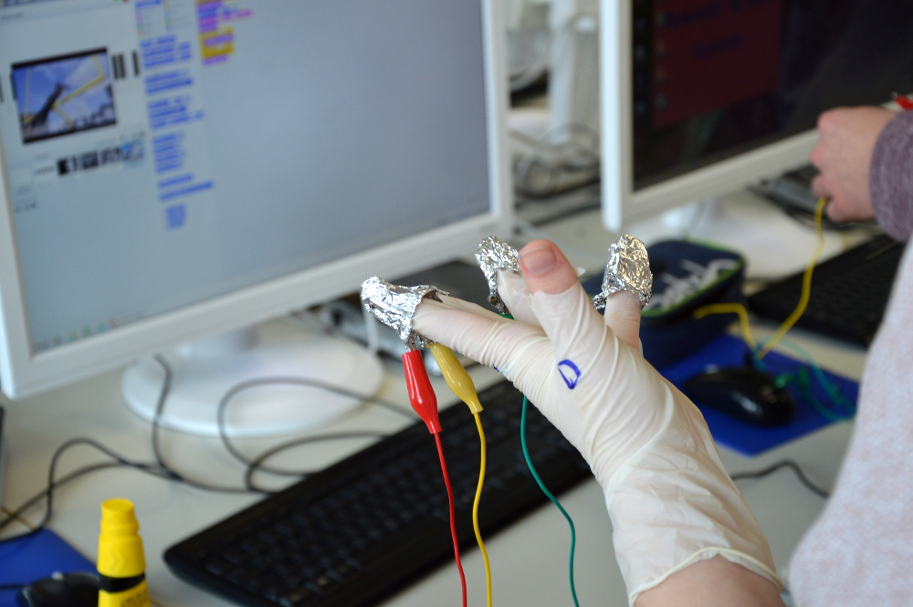 Verkabelte Hand, mit der ein Experiment durchgeführt wird.