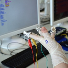 Wired hand with which an experiment is performed.