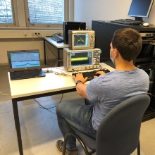 Student plays software back to hardware, for validation of GNSS algorithms developed at INS.