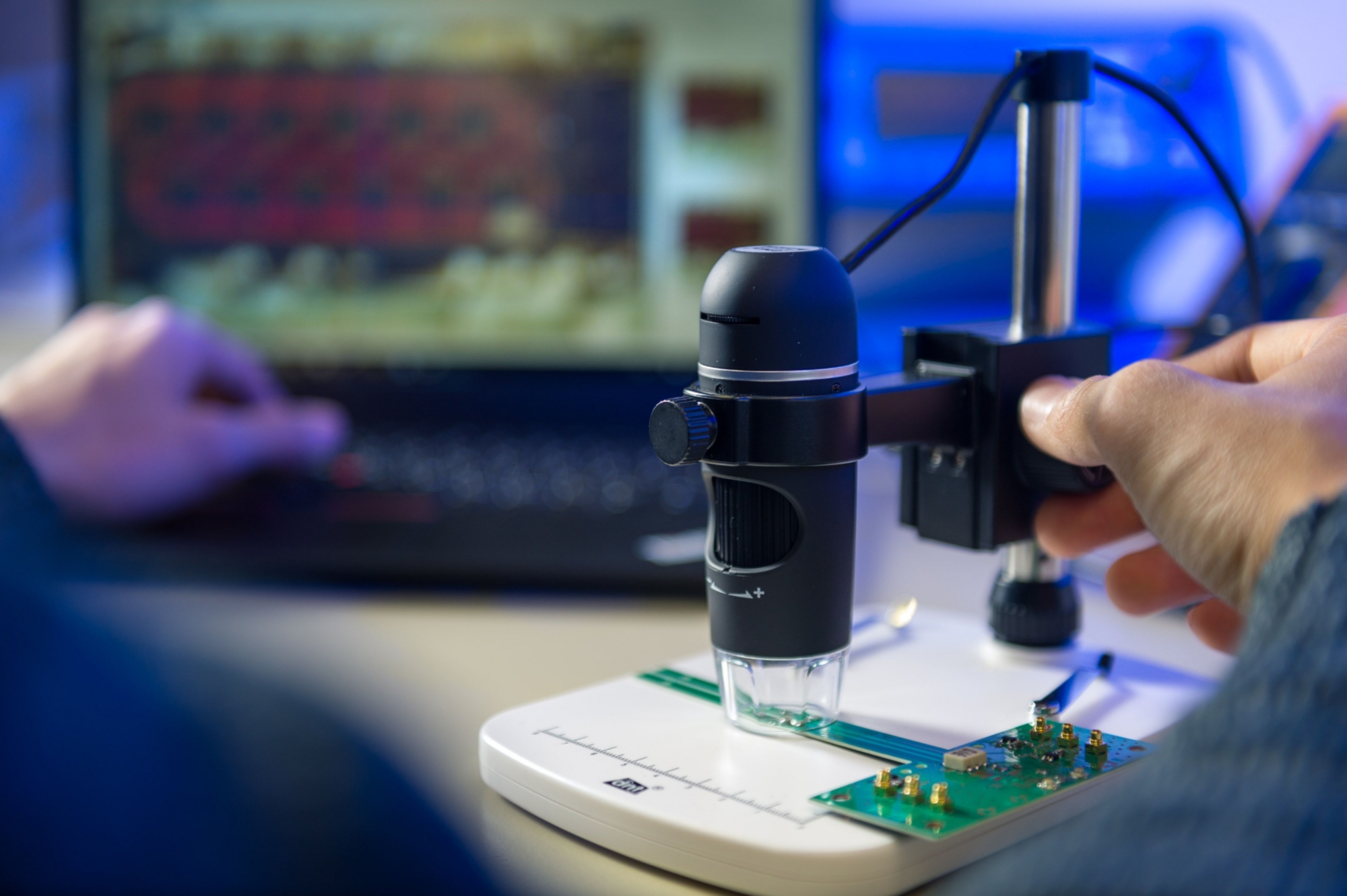 Probe head to manipulate and measure spins by using the integrated circuit visible in the background of the picture.