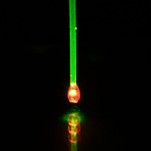 Diamond illuminated with green laser light. Due to the fluorescence light of the quantum sensors in diamond, it appears red.